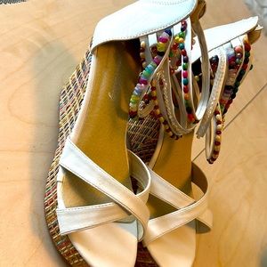 Wedge sandals with beaded ankle straps.
